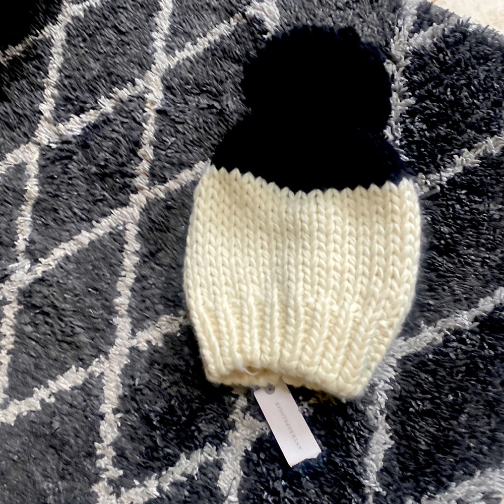 Anthropology, winter, warm hat w, ball women.One size. cream and black. New!!